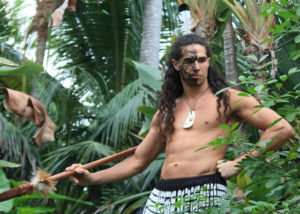Male Polynesian dancer in a warrior's pose in the Mai-Kai gardens.