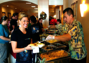 Close up view of a happy event participant being served at an off-site banquet catered by the Mai-Kai.