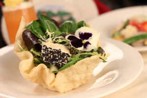 The Mai-Kai's signature Goat Cheese Salad with mixed greens in a crispy won ton shell.