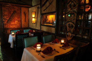 Close up of the intimate Polynesian setting of the Samoa dining room featuring many authentic artifacts.