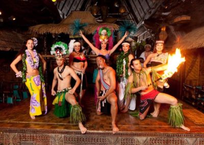 The Mai-Kai Polynesian Revue posing with fire on the stage of the Mai-Kai.