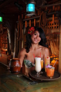 Sarong clad maiden serves the Mai-Kai classic Barrel O’ Rum in signature barrel mug along with a tray of classic Mai-Kai cocktails.