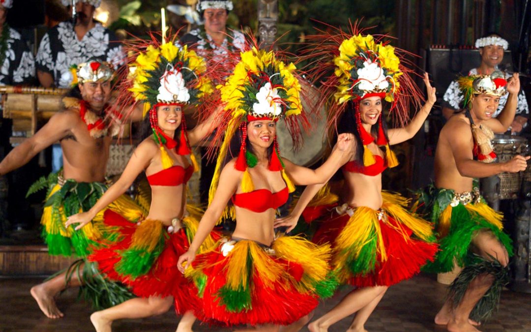 The Mai-Kai performers dressed in colorful costumes performing on the stage at Mai-Kai.