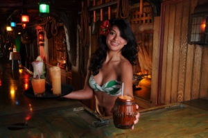 Sarong clad maiden serves the Mai-Kai classic Barrel O’ Rum in signature barrel mug.