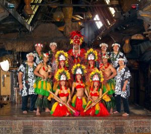 The full cast of the Mai-Kai Islander Revue in colorful costumes posing on the stage at the Mai-Kai.