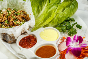 The Asian Chicken lettuce wrap appetizer with 3 sauces.