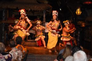 The Mai-Kai performers dressed in colorful costumes performing on the stage at Mai-Kai.